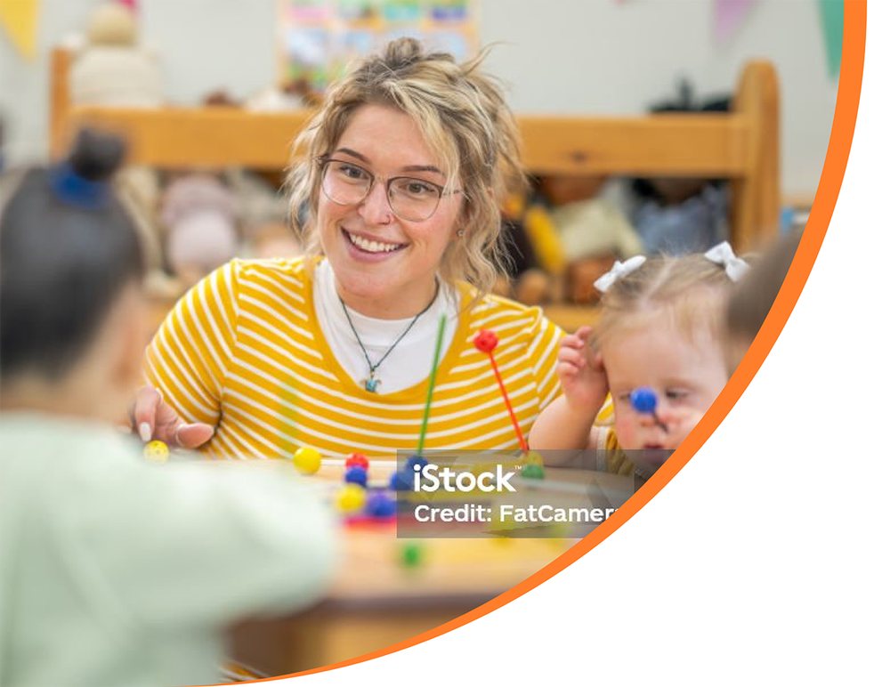 Teacher at table with very young students