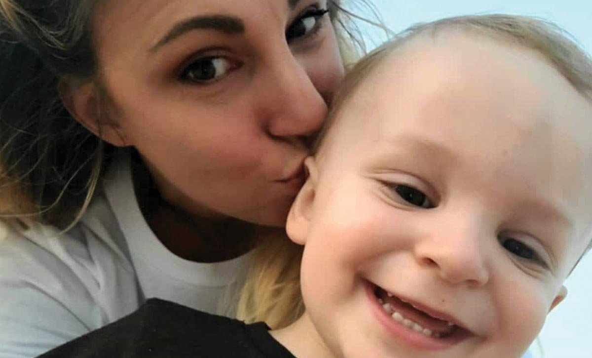 Mom kissing young son's head